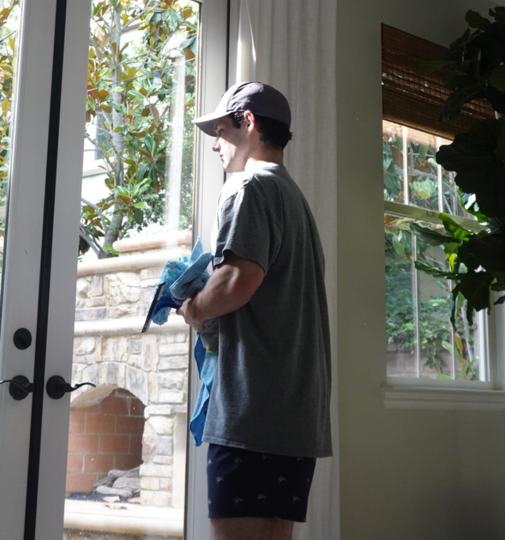 Ethan Malamatenios working on window cleaning
